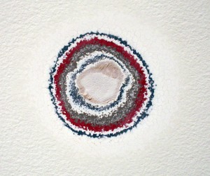 Previous layers of gallery paint revealed through sanding.